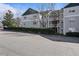 Three story apartment building with siding and well-maintained landscaping at 2011 Wolftech Ln # 203, Raleigh, NC 27603