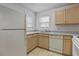 Well-lit kitchen with light wood cabinets and a view from the kitchen window at 2011 Wolftech Ln # 203, Raleigh, NC 27603
