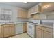 Bright kitchen featuring light wood cabinets and a window with natural light at 2011 Wolftech Ln # 203, Raleigh, NC 27603