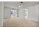 Open living room showcasing neutral carpet and natural light through windows at 2011 Wolftech Ln # 203, Raleigh, NC 27603