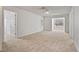 Spacious living room featuring neutral carpet and views into other living areas at 2011 Wolftech Ln # 203, Raleigh, NC 27603
