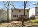 Spacious backyard view of a two-story home featuring a wooden deck and lots of windows at 209 Kellerhis Dr, Apex, NC 27502
