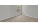 Neutral bedroom featuring cozy carpet, a window, and a simple aesthetic at 209 Kellerhis Dr, Apex, NC 27502