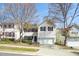 Two-story home featuring a two-car garage, black shutters, and mature trees in a suburban neighborhood at 209 Kellerhis Dr, Apex, NC 27502