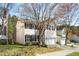 Home featuring a two-car garage and front yard, with mature trees providing shade at 209 Kellerhis Dr, Apex, NC 27502