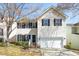 Charming home with white siding, black shutters, and a well-maintained front yard at 209 Kellerhis Dr, Apex, NC 27502