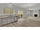 Open kitchen with stainless appliances, gray cabinets, and a view of the backyard deck at 209 Kellerhis Dr, Apex, NC 27502