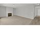 Neutral living room with a fireplace and beige carpet transitions to hard flooring at 209 Kellerhis Dr, Apex, NC 27502