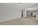 Bright living room with beige carpet flows into an open concept kitchen and staircase at 209 Kellerhis Dr, Apex, NC 27502