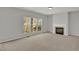 Bright living room with large windows and a cozy fireplace at 209 Kellerhis Dr, Apex, NC 27502