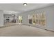 Bright open concept living room with large windows and view of the kitchen at 209 Kellerhis Dr, Apex, NC 27502
