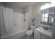 Well-lit bathroom features a shower-tub combination and a patterned tile floor at 221 Lane Of Tristram, Garner, NC 27529