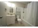 This clean bathroom has an updated shower-tub combination with tile surround at 221 Lane Of Tristram, Garner, NC 27529