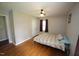 Comfortable bedroom with hardwood floors, ceiling fan, and a window providing natural light at 221 Lane Of Tristram, Garner, NC 27529