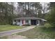 Exterior front view of home with a red door, screened-in porch, and a driveway at 221 Lane Of Tristram, Garner, NC 27529