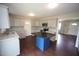 Updated kitchen featuring granite counters, an island, stainless steel appliances, and neutral cabinets at 221 Lane Of Tristram, Garner, NC 27529