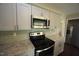 Well-equipped kitchen with stainless steel appliances, granite countertops, and ample cabinet space at 221 Lane Of Tristram, Garner, NC 27529