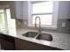 Close-up of granite countertop with a stainless steel sink and modern faucet in a kitchen at 221 Lane Of Tristram, Garner, NC 27529