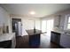 Modern kitchen with stainless steel appliances, granite counters, island, and ample storage space at 221 Lane Of Tristram, Garner, NC 27529