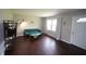 Comfortable living room featuring hardwood floors, a modern blue sofa, and ample natural light from the window at 221 Lane Of Tristram, Garner, NC 27529
