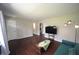 Spacious living room featuring dark hardwood floors, a modern sofa, and inviting natural light at 221 Lane Of Tristram, Garner, NC 27529