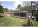 Exterior view of a sunroom with a grill and other outdoor items sitting next to it at 221 Lane Of Tristram, Garner, NC 27529