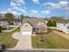 Expansive aerial view of a home with a spacious driveway, manicured lawn, and mature trees at 225 Beckwith Ave, Clayton, NC 27527