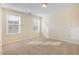 Well-lit bedroom featuring neutral walls, carpet, and two windows with blinds at 225 Beckwith Ave, Clayton, NC 27527