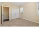 Empty bedroom with carpeted floors, a double-door closet, an extra closet, and lots of natural light at 225 Beckwith Ave, Clayton, NC 27527