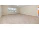 Spacious bonus room with carpet, three windows, and a view to an adjacent room at 225 Beckwith Ave, Clayton, NC 27527