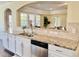 Kitchen with white cabinets and granite countertops overlooking an open living space with plenty of natural light at 225 Beckwith Ave, Clayton, NC 27527