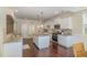 Spacious kitchen with white cabinets, granite counters, stainless appliances, and a center island with pendant lighting at 225 Beckwith Ave, Clayton, NC 27527