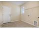 Laundry room with tile flooring, utility connections and wire rack shelving at 225 Beckwith Ave, Clayton, NC 27527