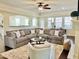 Spacious living room with a large sectional sofa, ceiling fan, and lots of natural light at 225 Beckwith Ave, Clayton, NC 27527