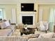 Cozy living room featuring a fireplace, hardwood floors, and elegant furnishings at 225 Beckwith Ave, Clayton, NC 27527
