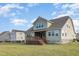 Back of house with a spacious lawn, deck, and fenced yard at 225 Beckwith Ave, Clayton, NC 27527