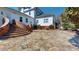 Backyard featuring stone paved area, brick stairs, and manicured shrubbery at 238 N Main St, Wake Forest, NC 27587