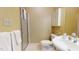 Bright bathroom features a glass-door shower, a toilet, and a vanity sink at 238 N Main St, Wake Forest, NC 27587