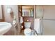 Well-lit bathroom with a pedestal sink, mirrored cabinet, and a walk-in shower at 238 N Main St, Wake Forest, NC 27587