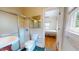 En suite bathroom featuring a tiled shower with glass doors and a view into the bedroom at 238 N Main St, Wake Forest, NC 27587