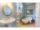Charming bathroom with clawfoot tub, vintage mirror, and decorative window at 238 N Main St, Wake Forest, NC 27587