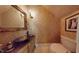Elegant powder room featuring an ornate mirror, vessel sink, and decorative wall finish at 238 N Main St, Wake Forest, NC 27587