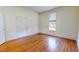 Spacious bedroom with hardwood floors, a large window, and neutral décor at 238 N Main St, Wake Forest, NC 27587