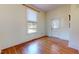 Bright bedroom with hardwood floors, a large window, and a white door at 238 N Main St, Wake Forest, NC 27587