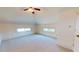 Spacious bedroom with plush carpet, ceiling fan, and dormer windows at 238 N Main St, Wake Forest, NC 27587