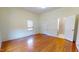 Large bedroom with hardwood floors, natural light, and an attached bathroom at 238 N Main St, Wake Forest, NC 27587
