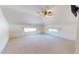 Spacious bedroom featuring plush carpet, ceiling fan, and dormer windows at 238 N Main St, Wake Forest, NC 27587