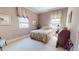 Cozy bedroom with floral bedding, soft natural light, and neutral tones at 238 N Main St, Wake Forest, NC 27587