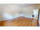 A spacious bedroom features hardwood floors and white trim with an adjoining bathroom at 238 N Main St, Wake Forest, NC 27587