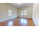 Bright bedroom featuring hardwood floors, neutral walls, and two large windows at 238 N Main St, Wake Forest, NC 27587